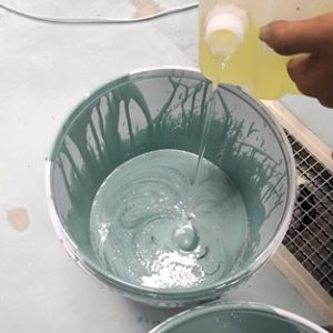 Pouring Hardener part into Resin part of Epoxy